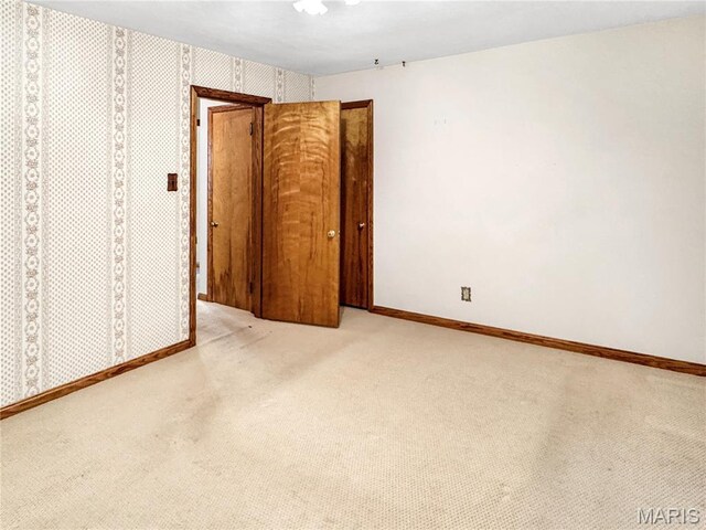 1508 3rd Pkwy, Washington, MO 63090 - unfurnished bedroom with carpet, baseboards, and wallpapered walls