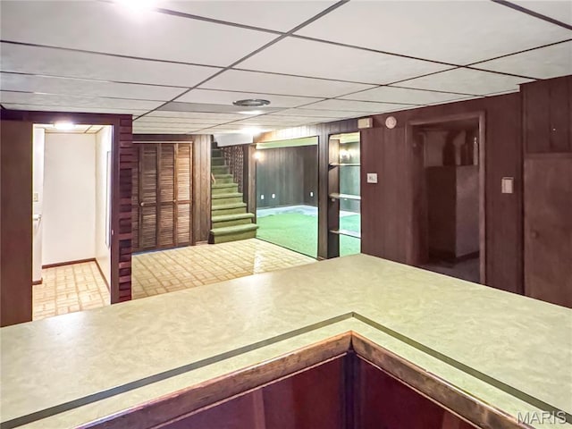 1508 3rd Pkwy, Washington, MO 63090 - kitchen with tile patterned floors, wood walls, a drop ceiling, and baseboards