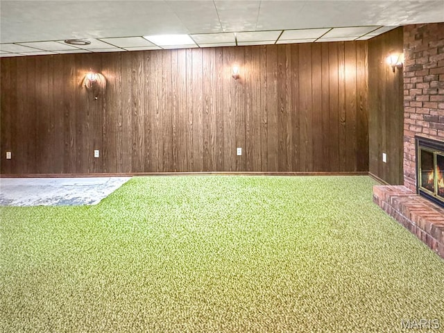 1508 3rd Pkwy, Washington, MO 63090 - finished below grade area with a brick fireplace, carpet flooring, wooden walls, and a paneled ceiling