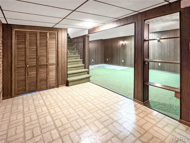 1508 3rd Pkwy, Washington, MO 63090 - finished basement featuring wood walls, brick patterned flooring, stairway, and a drop ceiling