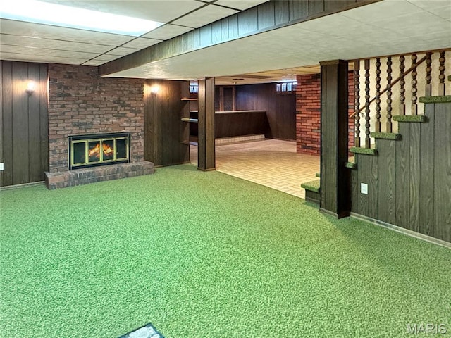 1508 3rd Pkwy, Washington, MO 63090 - finished below grade area with wood walls, a brick fireplace, and carpet flooring