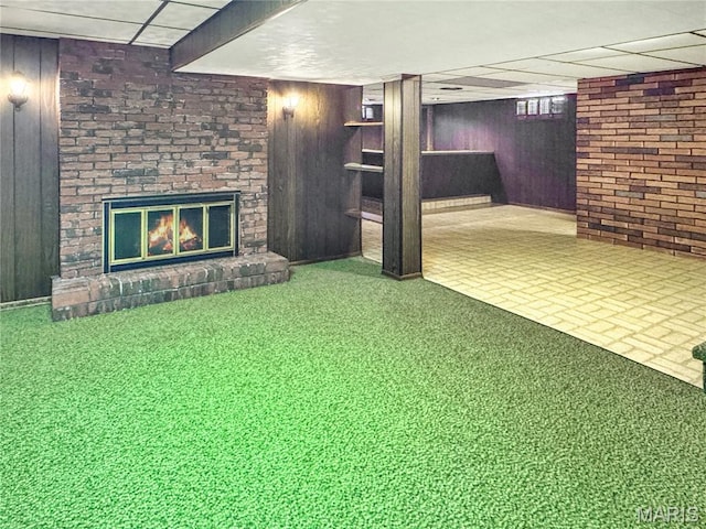 1508 3rd Pkwy, Washington, MO 63090 - finished below grade area with wooden walls, a fireplace, a paneled ceiling, and brick patterned floors