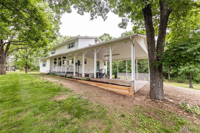 15701 County Road 1130, St James, MO 65559 - rear view of property with an attached carport, a yard, driveway, and a porch