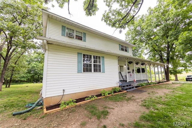 15701 County Road 1130, St James, MO 65559 - view of front facade featuring a porch and a front lawn