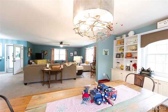 15701 County Road 1130, St James, MO 65559 - dining space featuring ceiling fan, a chandelier, and light wood-style floors