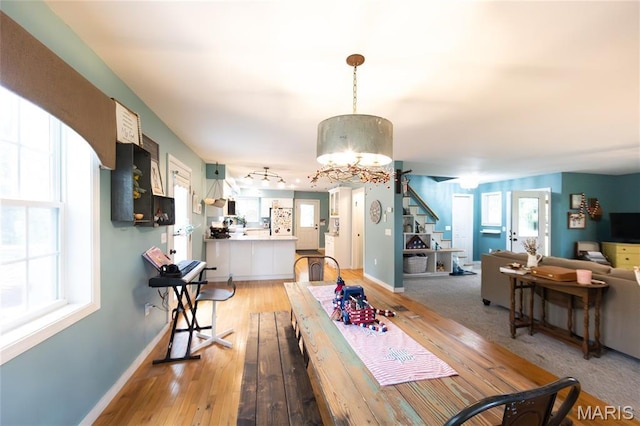 15701 County Road 1130, St James, MO 65559 - dining area featuring a chandelier, light wood-style floors, and stairs