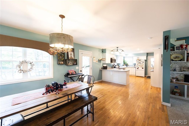 15701 County Road 1130, St James, MO 65559 - dining space with a chandelier and light wood-style flooring