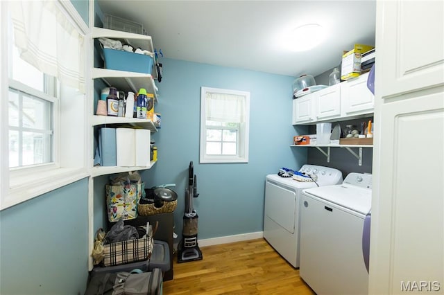 15701 County Road 1130, St James, MO 65559 - laundry area featuring cabinet space, separate washer and dryer, and light wood finished floors