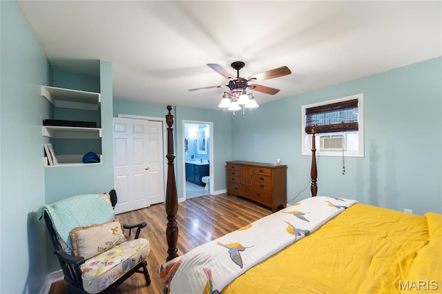 15701 County Road 1130, St James, MO 65559 - bedroom featuring wood finished floors, a closet, ensuite bath, ceiling fan, and cooling unit