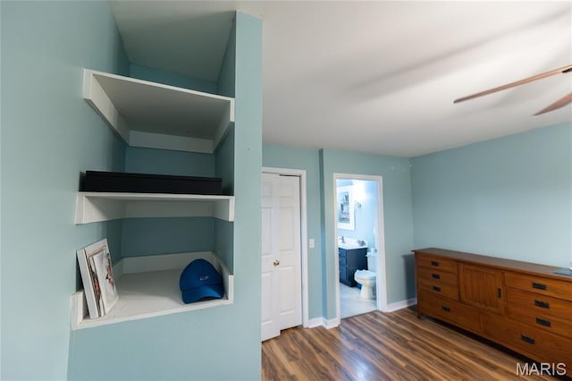 15701 County Road 1130, St James, MO 65559 - bedroom with wood finished floors, connected bathroom, and a closet