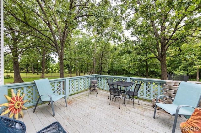 15701 County Road 1130, St James, MO 65559 - wooden terrace with outdoor dining space and view of wooded area