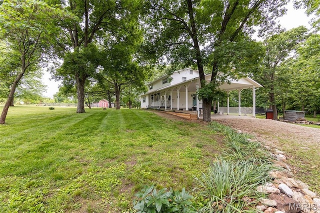 15701 County Road 1130, St James, MO 65559 - view of green lawn featuring dirt driveway, covered porch, and a carport