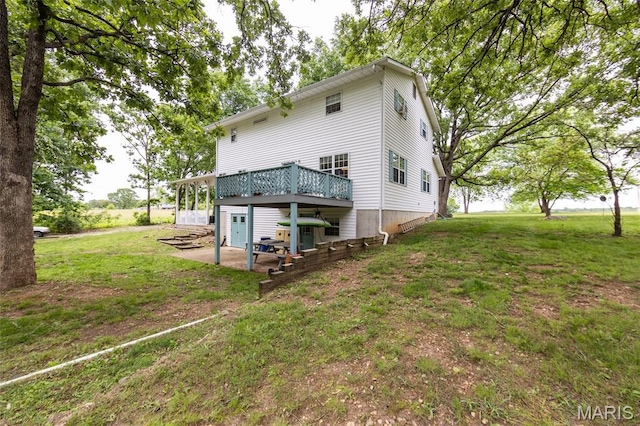 15701 County Road 1130, St James, MO 65559 - rear view of house featuring a lawn, a wooden deck, and a patio area