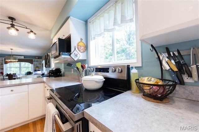 15701 County Road 1130, St James, MO 65559 - kitchen with stainless steel range with electric stovetop, white cabinets, light countertops, and wood finished floors