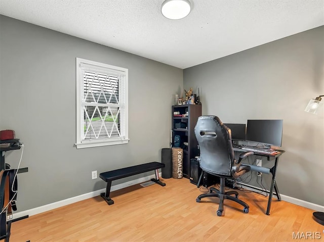 1015 Marilyn Ct, Washington, MO 63090 - office area with wood finished floors and a textured ceiling