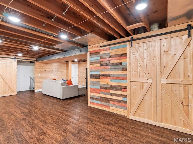 1015 Marilyn Ct, Washington, MO 63090 - finished basement with a barn door, wooden walls, and dark wood finished floors