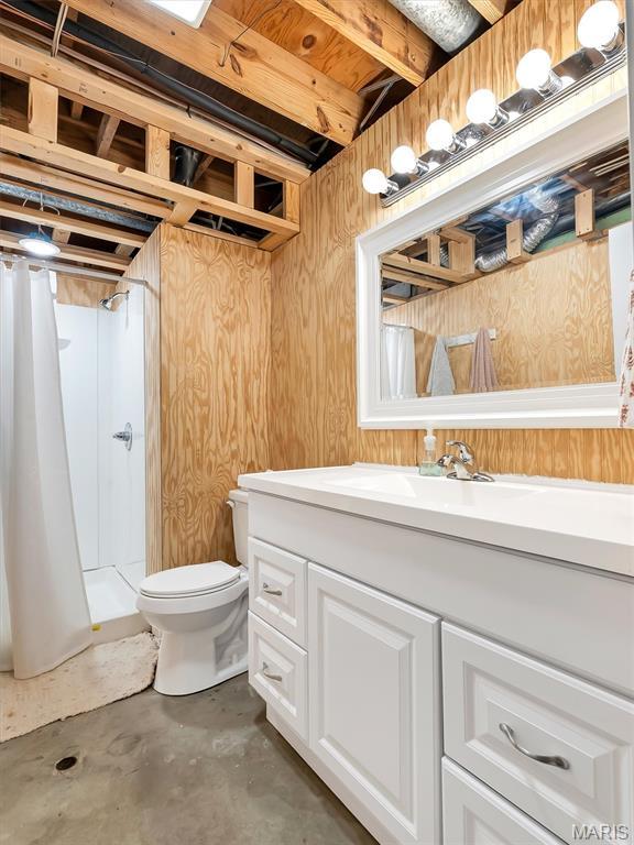 1015 Marilyn Ct, Washington, MO 63090 - bathroom featuring unfinished concrete flooring, vanity, and a shower with shower curtain