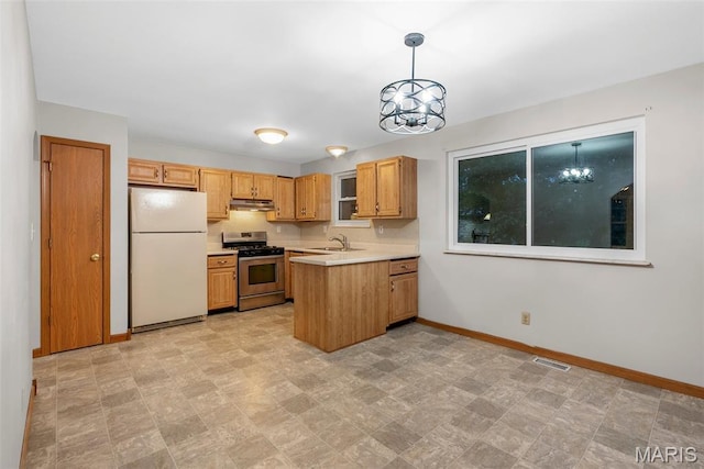 4618 Towne Hall Dr, Arnold, MO 63010 - kitchen featuring freestanding refrigerator, gas range, under cabinet range hood, baseboards, and light countertops