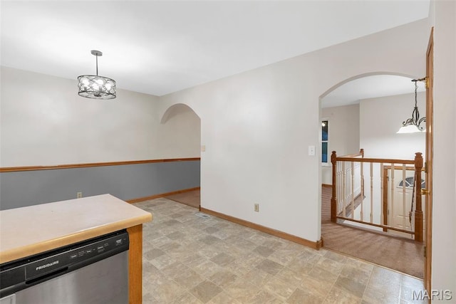 4618 Towne Hall Dr, Arnold, MO 63010 - kitchen with stainless steel dishwasher, arched walkways, light floors, baseboards, and pendant lighting