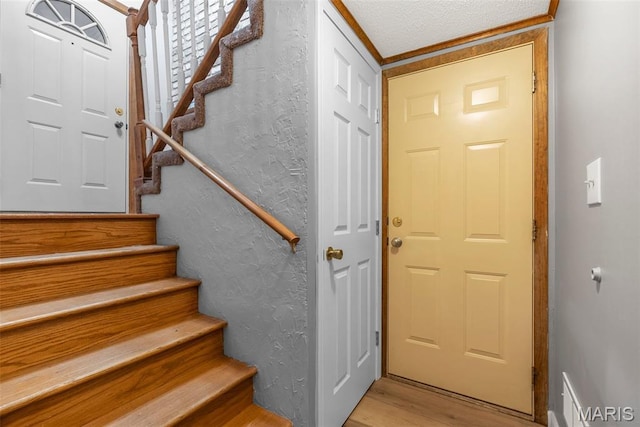 4618 Towne Hall Dr, Arnold, MO 63010 - stairway with wood finished floors, a textured wall, and a textured ceiling