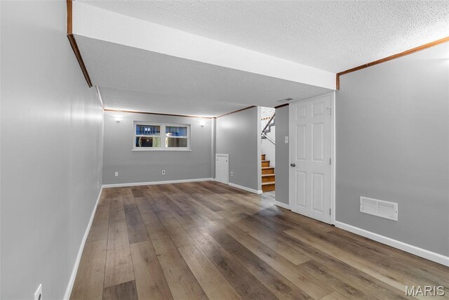 4618 Towne Hall Dr, Arnold, MO 63010 - finished basement featuring wood-type flooring, a textured ceiling, baseboards, and stairway