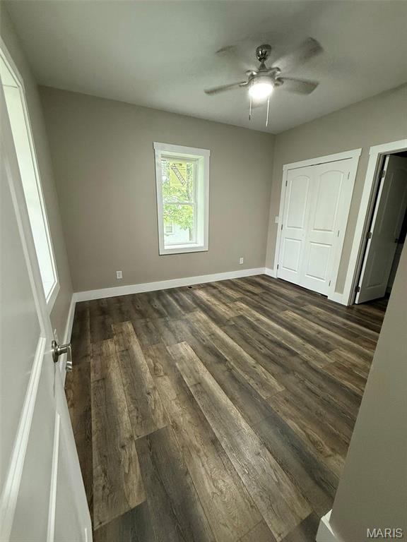 618 Taylor Ave, Park Hills, MO 63601 - unfurnished bedroom featuring dark wood-type flooring, baseboards, ceiling fan, and a closet