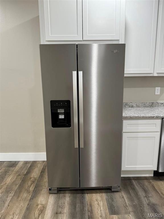 618 Taylor Ave, Park Hills, MO 63601 - kitchen view of stainless steel fridge with ice dispenser, dark wood-style flooring, and white cabinets