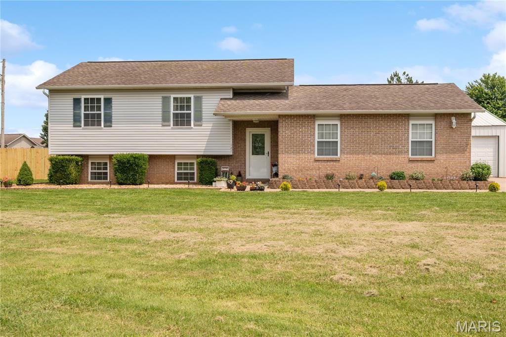 121 Melissas Dr, Jackson, MO 63755 - split level home with brick siding, a garage, and roof with shingles