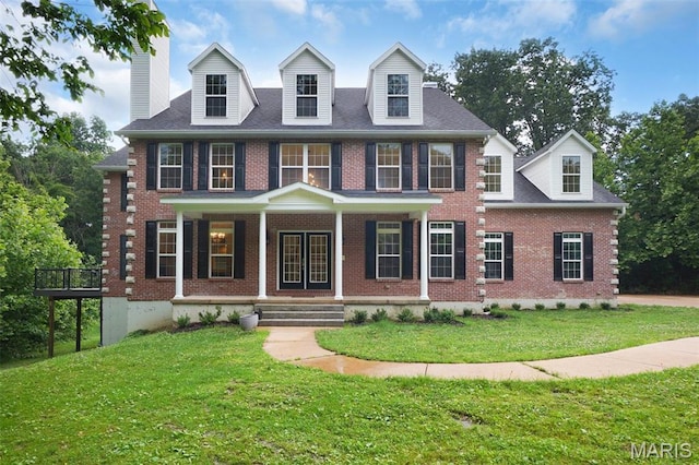 17917 Rosemar Ln, Wildwood, MO 63038 - georgian-style home featuring brick siding, a porch, a front yard, and french doors