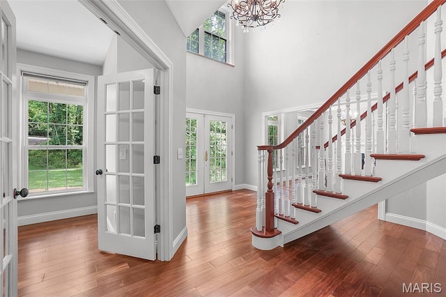 17917 Rosemar Ln, Wildwood, MO 63038 - entryway featuring french doors, a chandelier, wood finished floors, a towering ceiling, and stairway