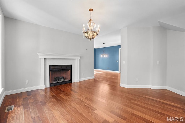 17917 Rosemar Ln, Wildwood, MO 63038 - unfurnished living room featuring a chandelier, wood finished floors, and a fireplace