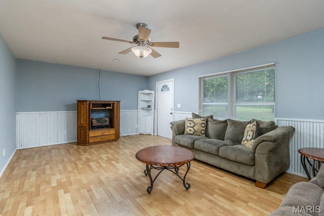 22250 Keepsake Rd, Lebanon, MO 65536 - living room with light wood-type flooring, wainscoting, and a ceiling fan