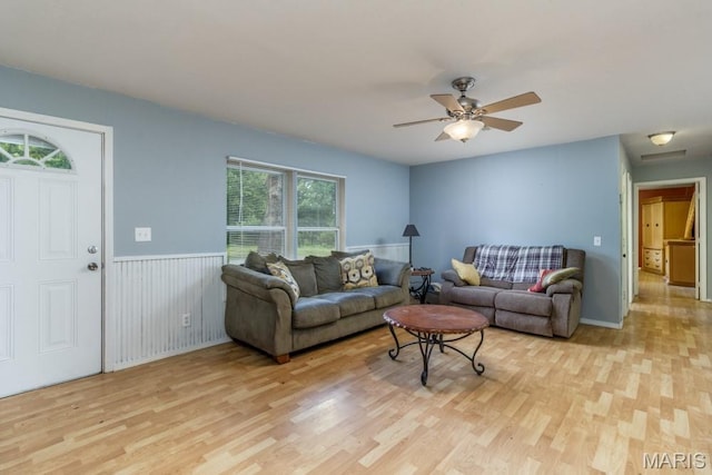 22250 Keepsake Rd, Lebanon, MO 65536 - living area with light wood-type flooring, ceiling fan, and a wainscoted wall