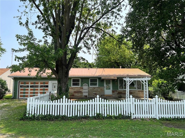 503 Cumberland St, Coffeen, IL 62017 - single story home featuring an attached garage, stone siding, a fenced front yard, and metal roof