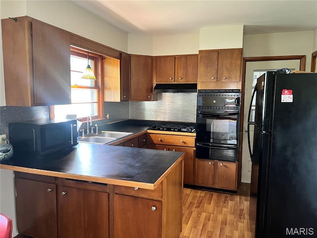 503 Cumberland St, Coffeen, IL 62017 - kitchen featuring black appliances, a sink, a warming drawer, a peninsula, and dark countertops