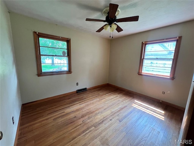 503 Cumberland St, Coffeen, IL 62017 - unfurnished room featuring healthy amount of natural light, light wood-style floors, baseboards, and a ceiling fan
