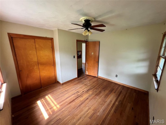 503 Cumberland St, Coffeen, IL 62017 - unfurnished bedroom with baseboards, wood finished floors, a closet, and a ceiling fan