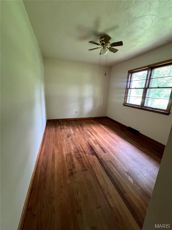 503 Cumberland St, Coffeen, IL 62017 - spare room with wood finished floors, a ceiling fan, and baseboards