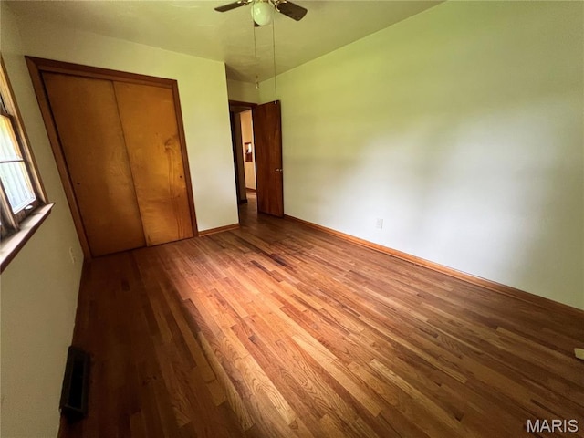 503 Cumberland St, Coffeen, IL 62017 - unfurnished bedroom with wood finished floors, a closet, a ceiling fan, and baseboards