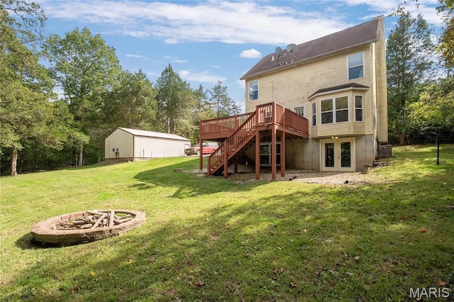 7611 State Route 30, Dittmer, MO 63023 - back of house with an outdoor fire pit, stairs, a deck, french doors, and a yard