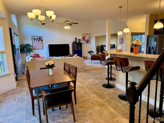 5005 Double Tree Dr, Imperial, MO 63052 - dining room with a chandelier, baseboards, ceiling fan, and stone finish floors