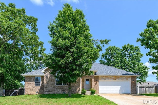 128 Mesa Dr, Waynesville, MO 65583 - view of front of property with an attached garage, concrete driveway, brick siding, and roof with shingles