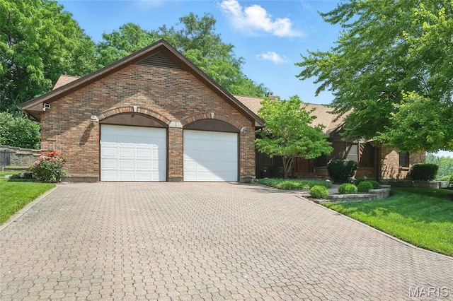 55 Cambrian Way, Saint Charles, MO 63301 - view of front of home featuring brick siding, decorative driveway, an attached garage, and a front yard