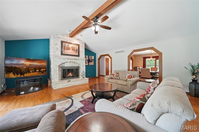 55 Cambrian Way, Saint Charles, MO 63301 - living room featuring arched walkways, ceiling fan, wood finished floors, and a stone fireplace