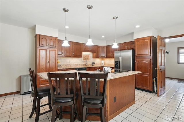 55 Cambrian Way, Saint Charles, MO 63301 - kitchen featuring stainless steel refrigerator with ice dispenser, dishwasher, tasteful backsplash, a kitchen island, and light tile patterned floors