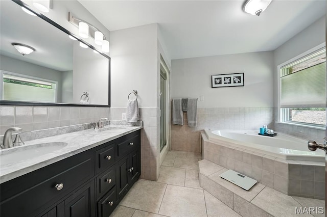 55 Cambrian Way, Saint Charles, MO 63301 - full bath with tile patterned floors, a bath, double vanity, tile walls, and a stall shower