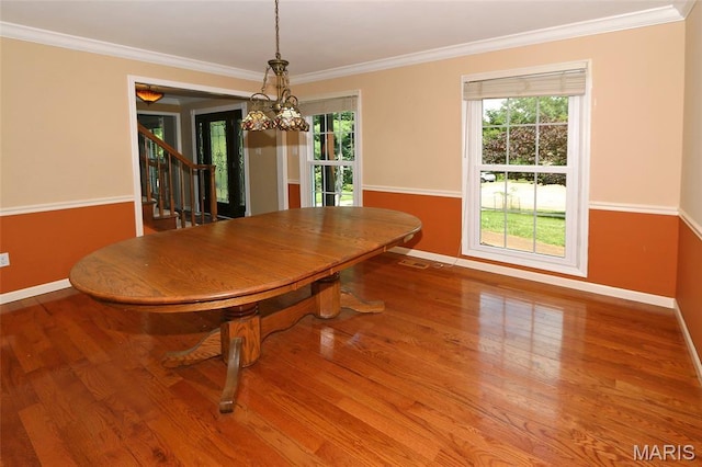2003 Centennial Ct, Wildwood, MO 63011 - dining area featuring healthy amount of natural light, crown molding, stairway, and wood finished floors