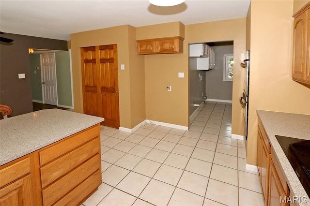 2003 Centennial Ct, Wildwood, MO 63011 - kitchen featuring light countertops, light tile patterned floors, and black electric cooktop