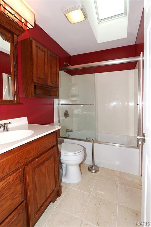 2003 Centennial Ct, Wildwood, MO 63011 - full bath with vanity, enclosed tub / shower combo, a skylight, and tile patterned floors