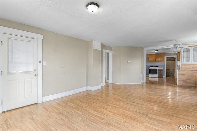 503 Newberry St, Fredericktown, MO 63645 - unfurnished living room with a ceiling fan, light wood finished floors, a textured ceiling, and baseboards